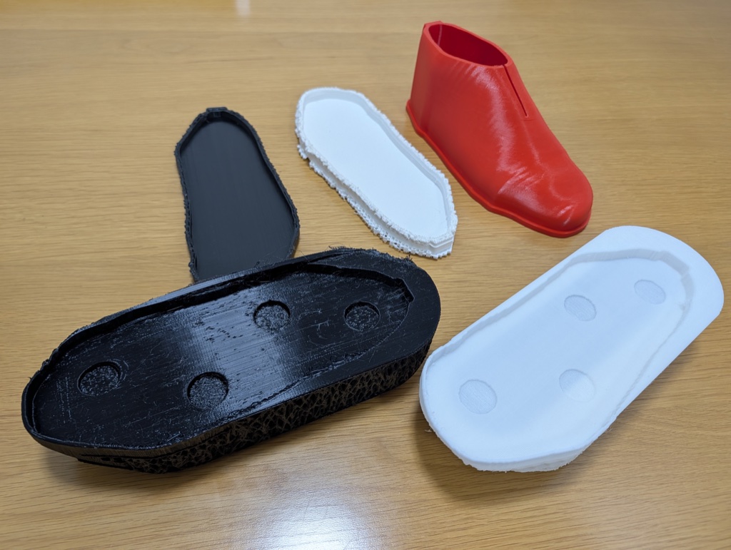 A table of failed and prototype prints, including a red test upper
