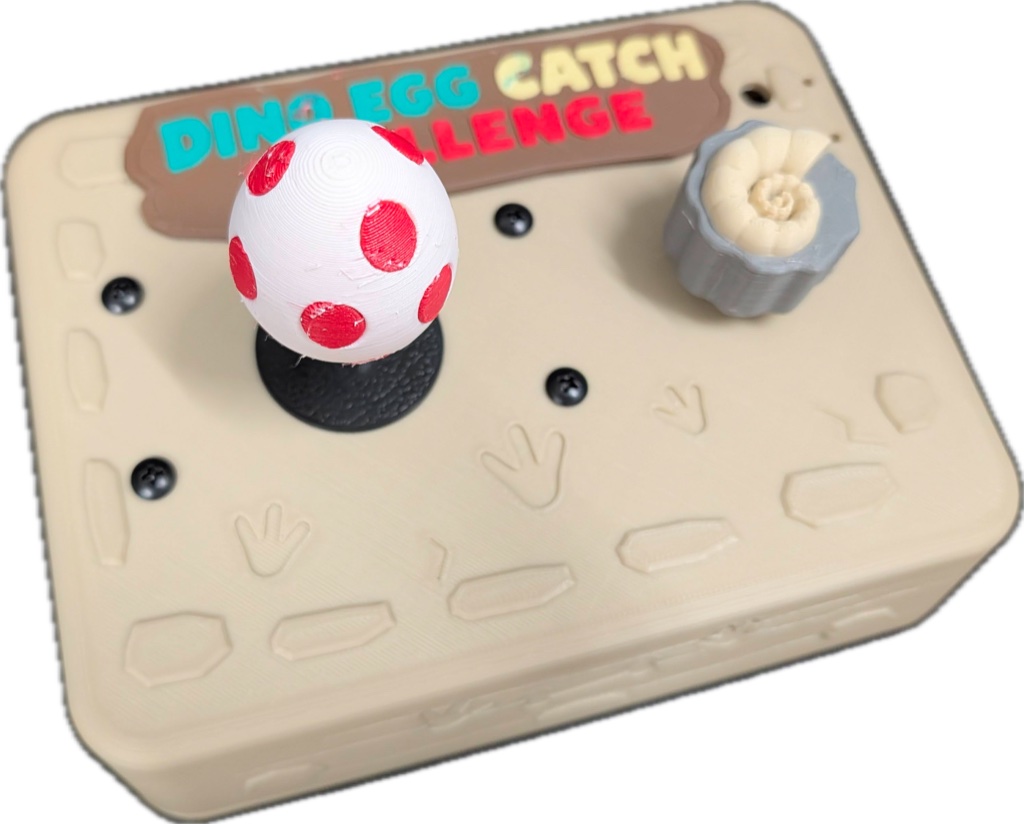The 3D-printed dino controller with a spotted-egg joystick and a fossil-shaped dial